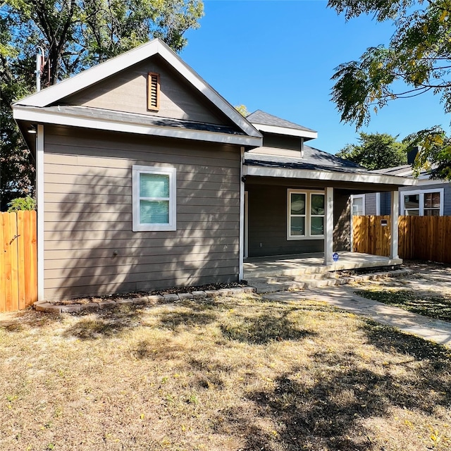 view of front of property with a patio and a front lawn