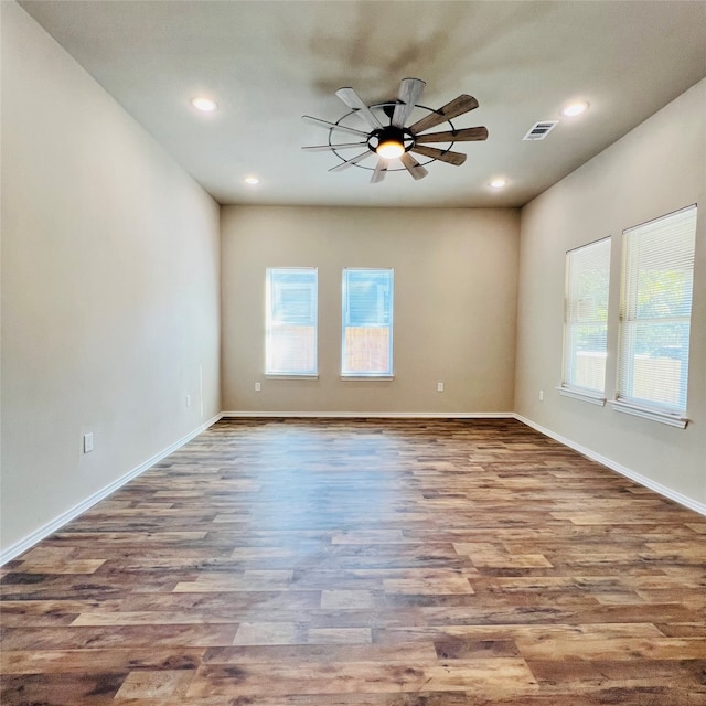 unfurnished room with hardwood / wood-style flooring, ceiling fan, and a wealth of natural light