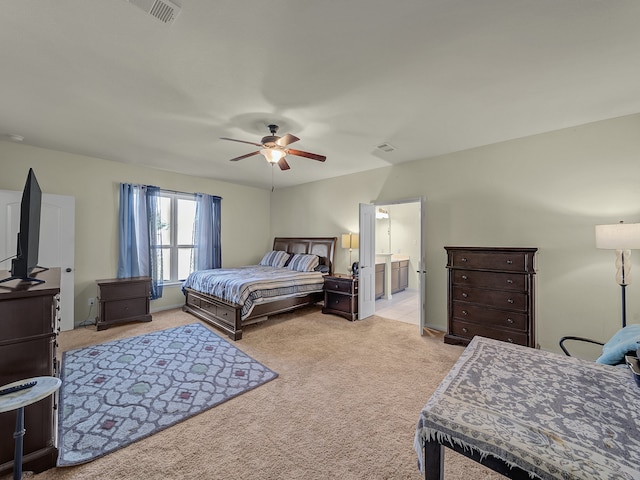 bedroom featuring connected bathroom, ceiling fan, and light colored carpet