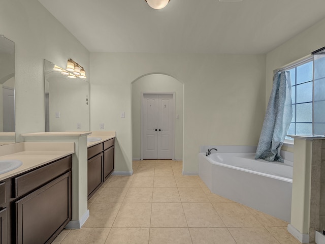 bathroom featuring vanity, a tub, and tile patterned floors