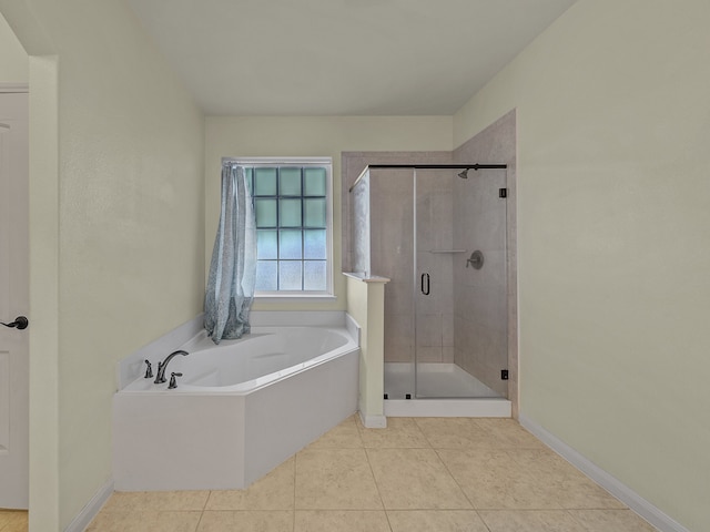 bathroom featuring tile patterned floors and separate shower and tub