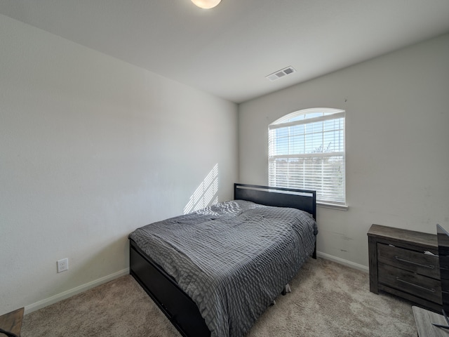 bedroom featuring light colored carpet