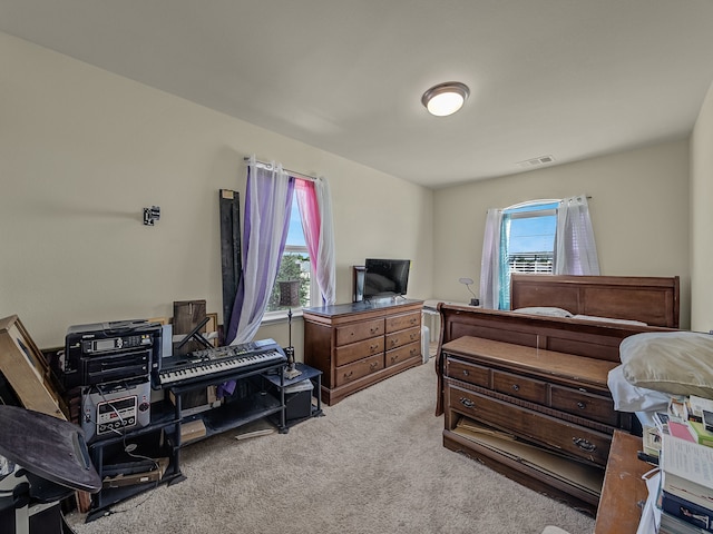 carpeted bedroom featuring multiple windows