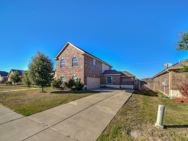 view of front of home with a front yard and a garage