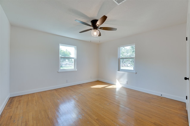 spare room featuring light wood-type flooring and ceiling fan