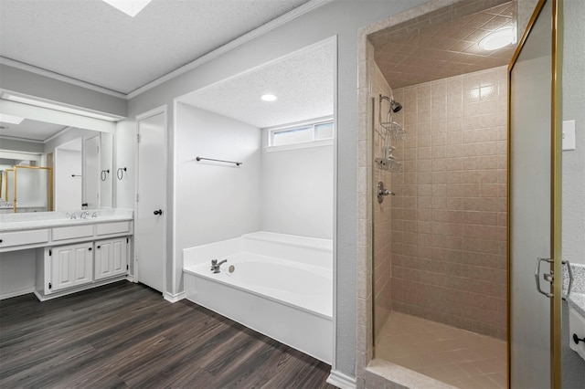 bathroom with vanity, crown molding, independent shower and bath, and hardwood / wood-style floors