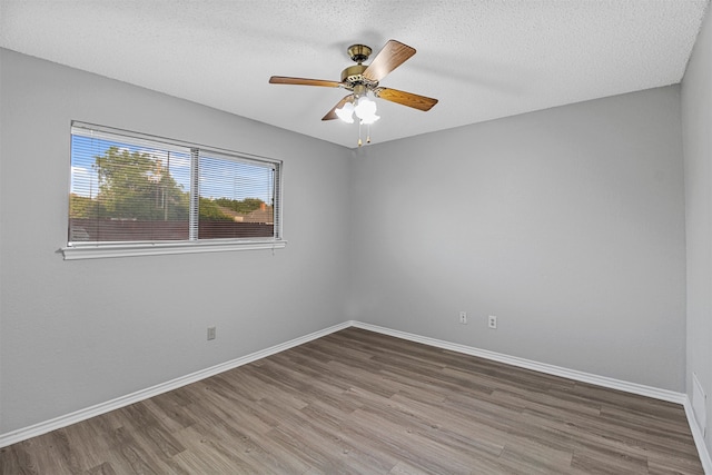 spare room featuring hardwood / wood-style floors, a textured ceiling, and ceiling fan