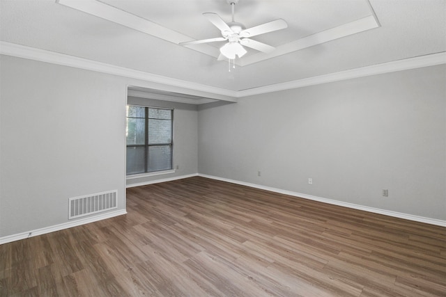 empty room with ornamental molding, wood-type flooring, and ceiling fan