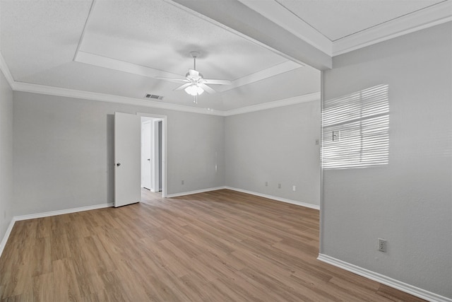 empty room featuring ornamental molding, light wood-type flooring, and ceiling fan