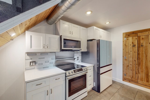 kitchen featuring stainless steel appliances, light tile patterned flooring, wooden ceiling, backsplash, and white cabinets