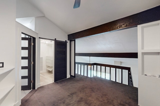 interior space with a barn door, light carpet, and vaulted ceiling with beams