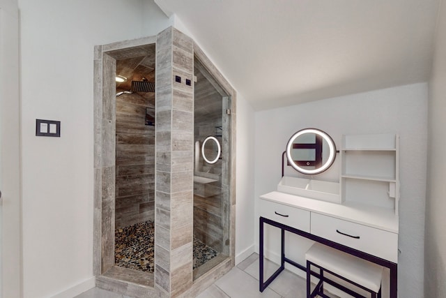 bathroom with vanity, tile patterned floors, and a tile shower