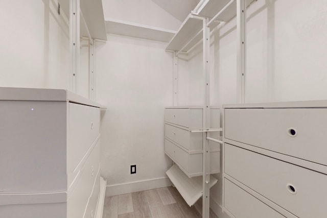 spacious closet with light hardwood / wood-style floors