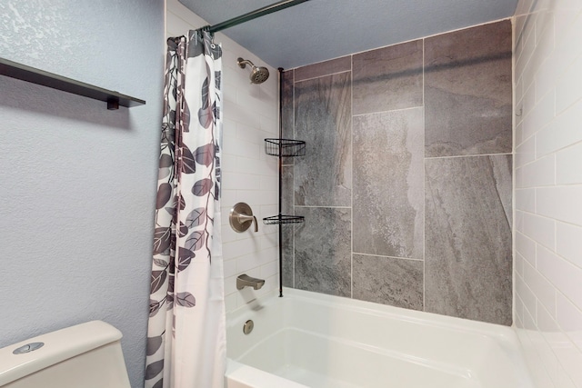 bathroom with a textured ceiling, shower / bath combination with curtain, and toilet