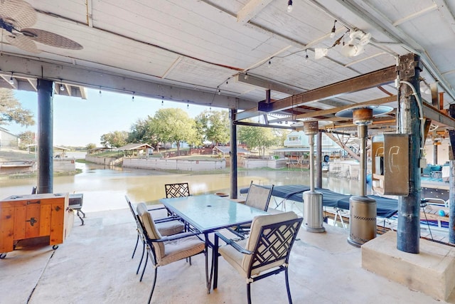 view of patio / terrace with ceiling fan and a water view