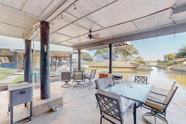 view of patio featuring a water view and ceiling fan