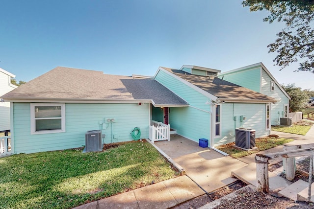 back of property with a lawn and cooling unit