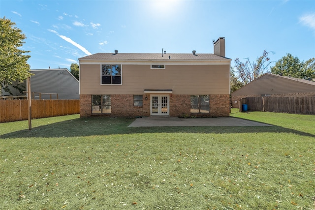 rear view of house featuring a patio, french doors, and a yard