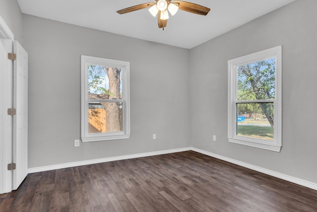 empty room featuring dark hardwood / wood-style floors, plenty of natural light, and ceiling fan