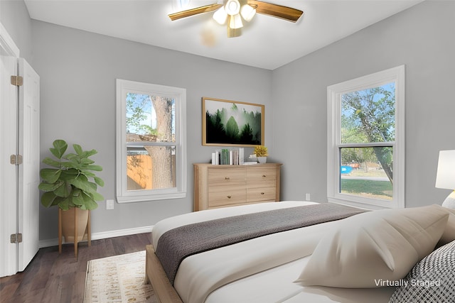 bedroom with ceiling fan and dark hardwood / wood-style floors