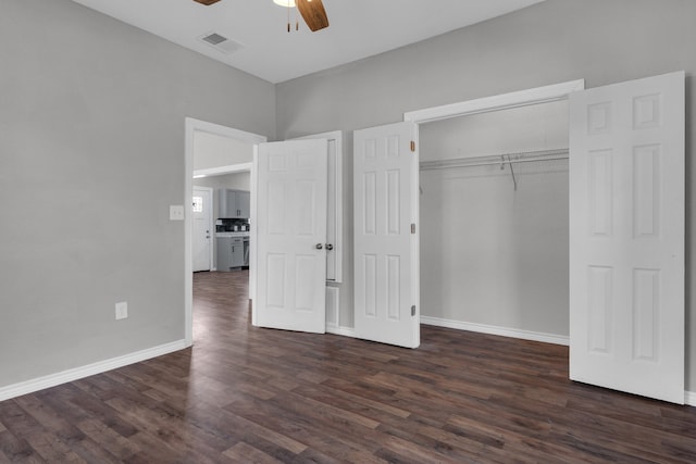 unfurnished bedroom with a closet, dark hardwood / wood-style floors, and ceiling fan