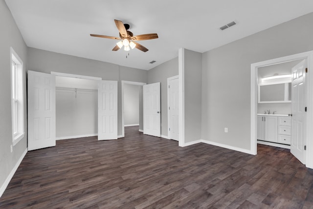 unfurnished bedroom with sink, ensuite bath, dark hardwood / wood-style flooring, a closet, and ceiling fan