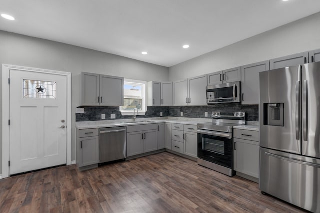 kitchen featuring sink, gray cabinetry, stainless steel appliances, and dark hardwood / wood-style floors