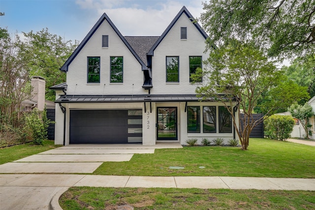 modern inspired farmhouse featuring a front yard and a garage