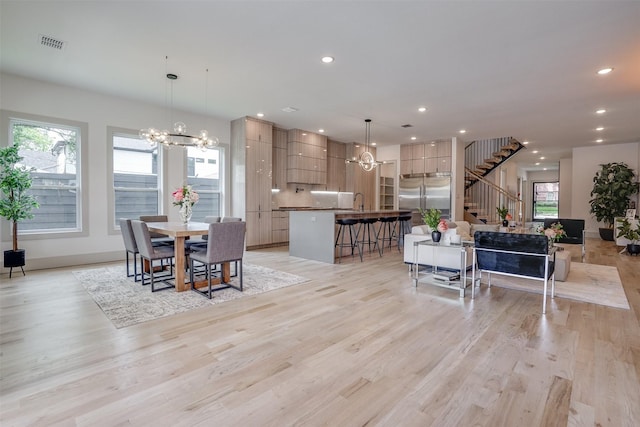 3732 Valley Ridge Rd, Dallas, TX 75220 - dining space featuring stairway, healthy amount of natural light, a chandelier, light wood-style flooring, and recessed lighting