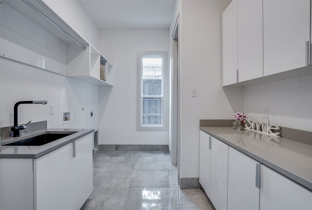 washroom with washer hookup, cabinets, and sink