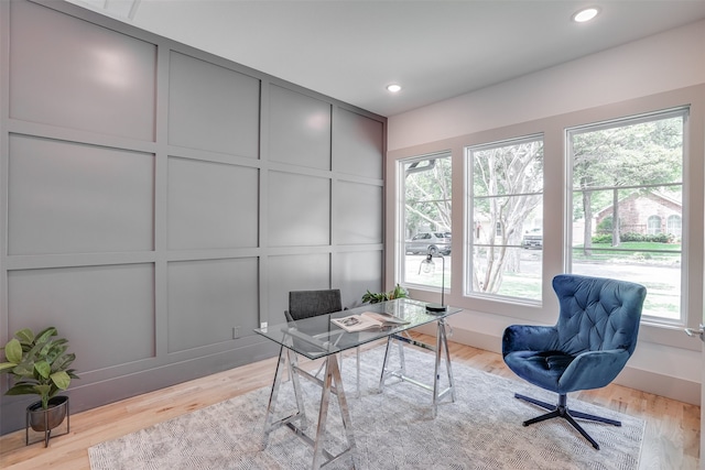 office area with a wealth of natural light and light hardwood / wood-style flooring