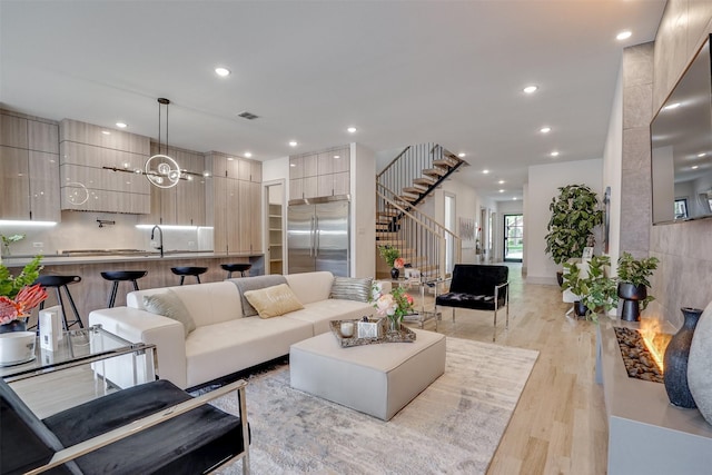 3732 Valley Ridge Rd, Dallas, TX 75220 - living room featuring stairway, light wood finished floors, recessed lighting, and a chandelier