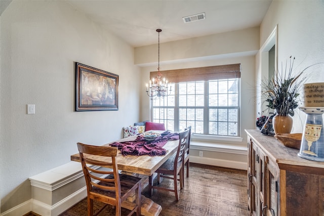 dining area featuring a notable chandelier and dark hardwood / wood-style flooring