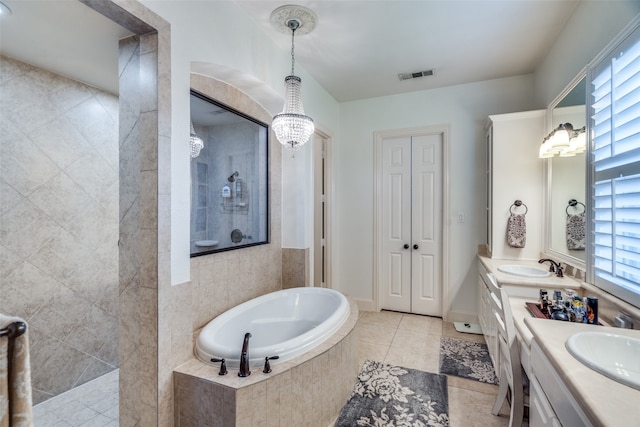 bathroom featuring vanity, plus walk in shower, tile patterned floors, and a wealth of natural light