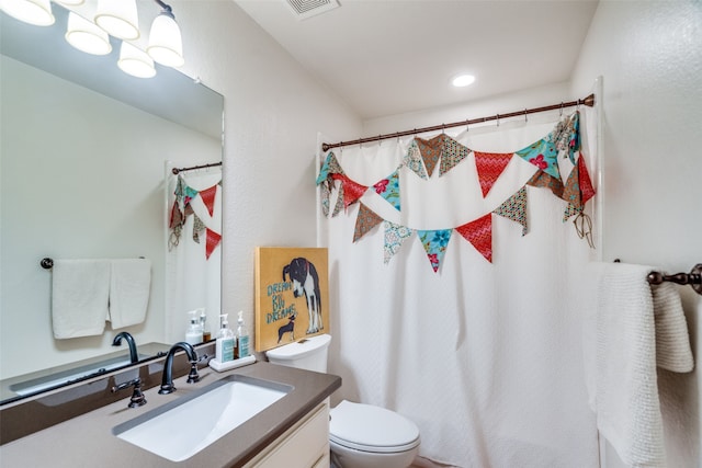 bathroom with vanity, toilet, and a shower with shower curtain