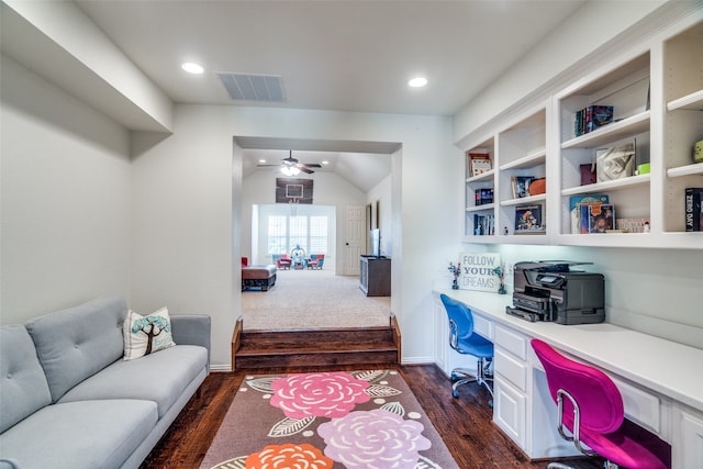 office area featuring built in desk, lofted ceiling, dark wood-type flooring, and ceiling fan