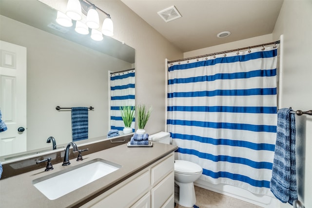 bathroom with vanity, toilet, and tile patterned flooring