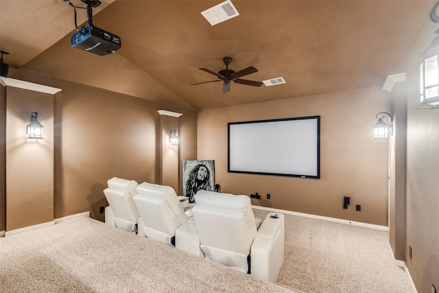 carpeted home theater room featuring ceiling fan and vaulted ceiling