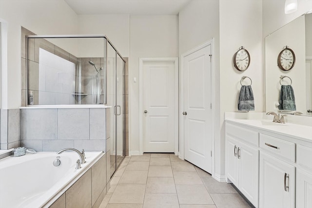 bathroom with vanity, tile patterned floors, and shower with separate bathtub