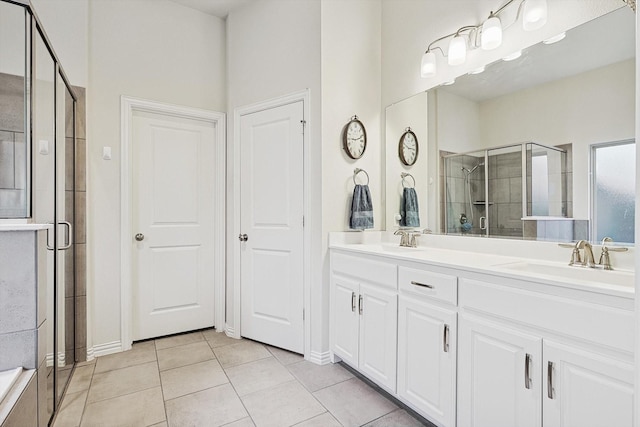 bathroom featuring an enclosed shower, tile patterned flooring, and vanity