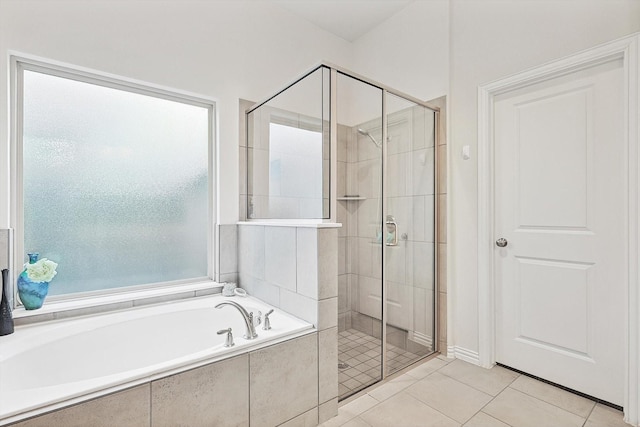 bathroom featuring tile patterned flooring and independent shower and bath