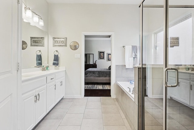 bathroom featuring shower with separate bathtub, vanity, and tile patterned floors