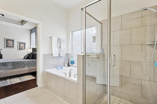 bathroom with shower with separate bathtub, tile patterned floors, and a healthy amount of sunlight