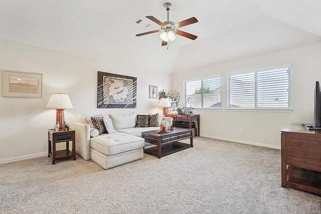 living room with ceiling fan, vaulted ceiling, and light colored carpet