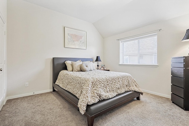 bedroom with vaulted ceiling and light carpet