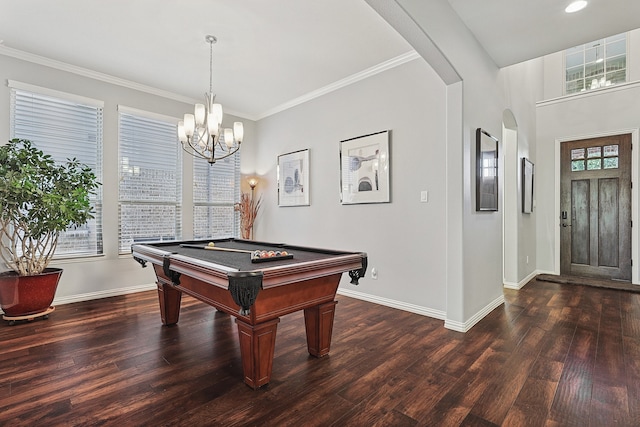 game room with dark hardwood / wood-style flooring, pool table, an inviting chandelier, and ornamental molding