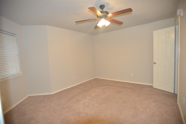 empty room featuring light carpet and ceiling fan