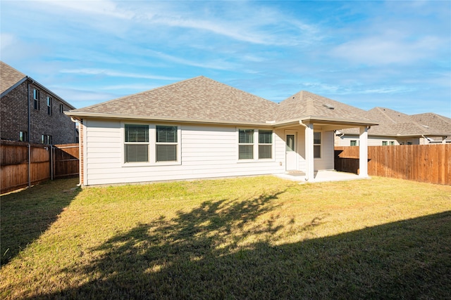 rear view of house featuring a patio area and a lawn