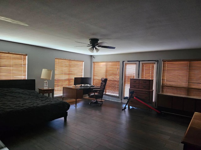 bedroom featuring ceiling fan, a textured ceiling, and dark hardwood / wood-style floors