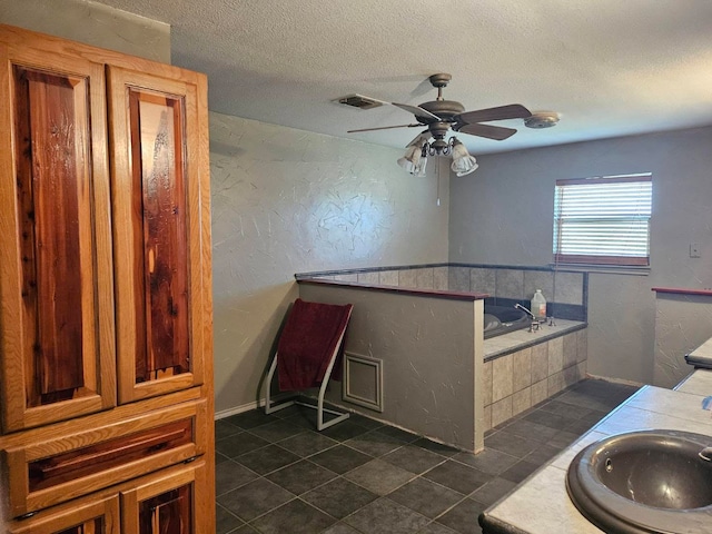 bathroom with a bathtub, ceiling fan, sink, and tile patterned flooring